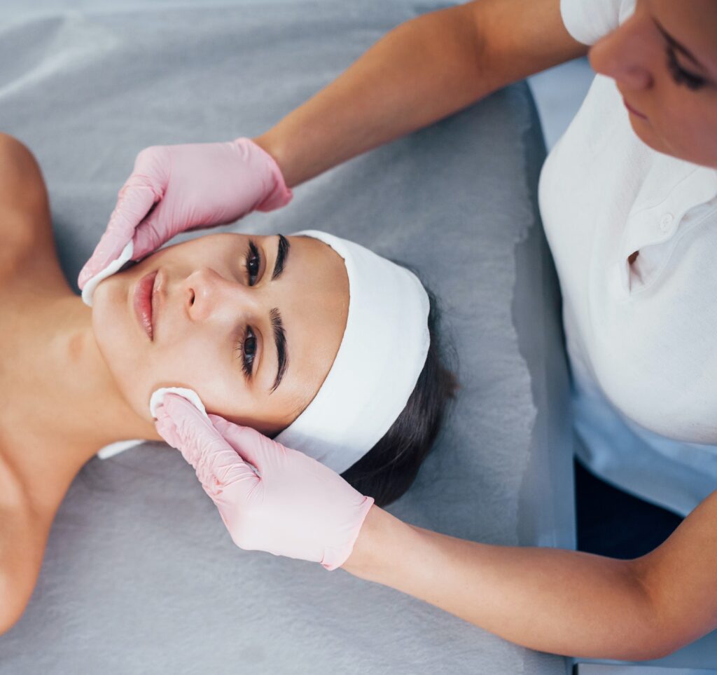 Close up view of woman that lying down in spa salon and have face cleaning procedure