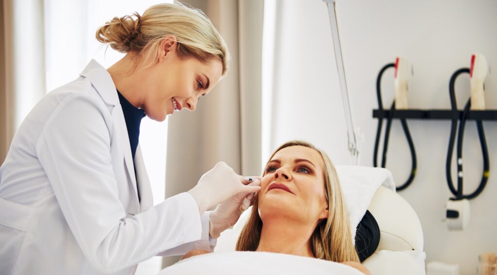 Doctor doing botox injections on a mature woman's face